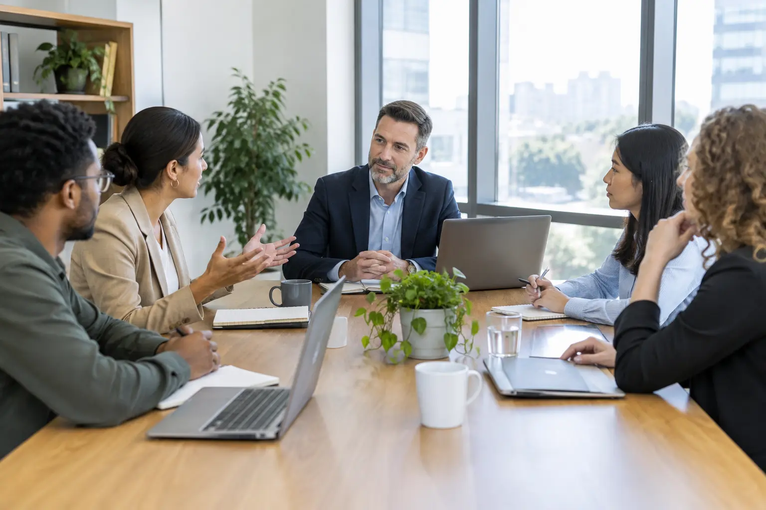 Manager listening during a team meeting in a bright office